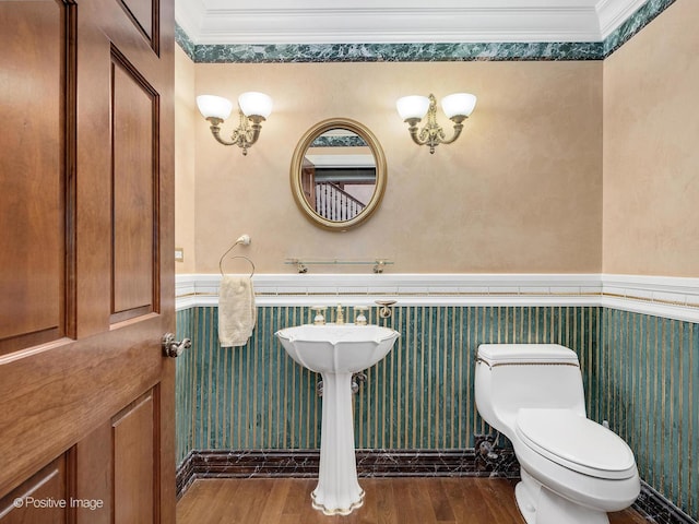 6 Swaps Ct, Oak Brook, IL 60523 - half bathroom featuring crown molding, wainscoting, and wood finished floors