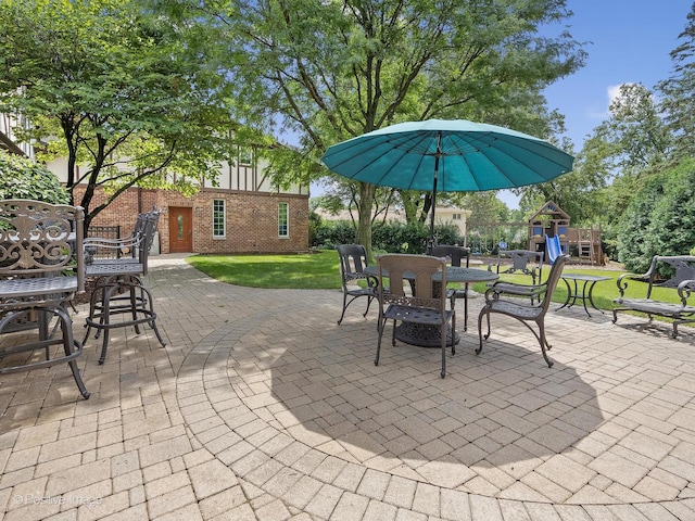 6 Swaps Ct, Oak Brook, IL 60523 - view of patio featuring outdoor dining space and a playground