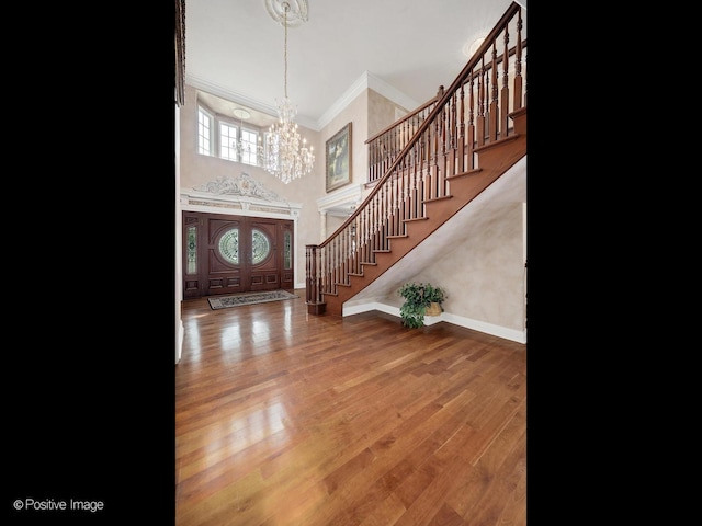 6 Swaps Ct, Oak Brook, IL 60523 - entrance foyer featuring crown molding, stairs, a chandelier, a towering ceiling, and wood finished floors