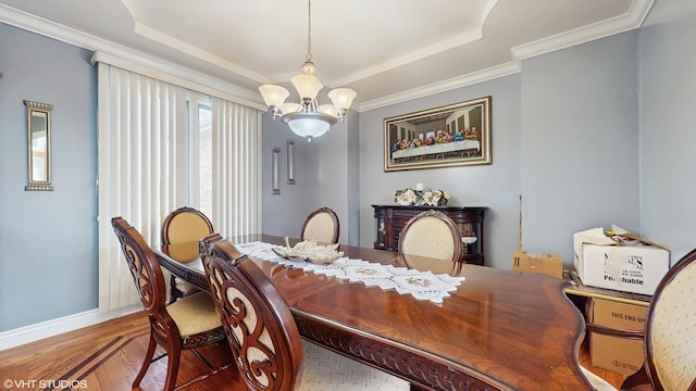17040 Cheyenne Ct, Lockport, IL 60441 - dining area with a chandelier, a raised ceiling, wood finished floors, baseboards, and ornamental molding