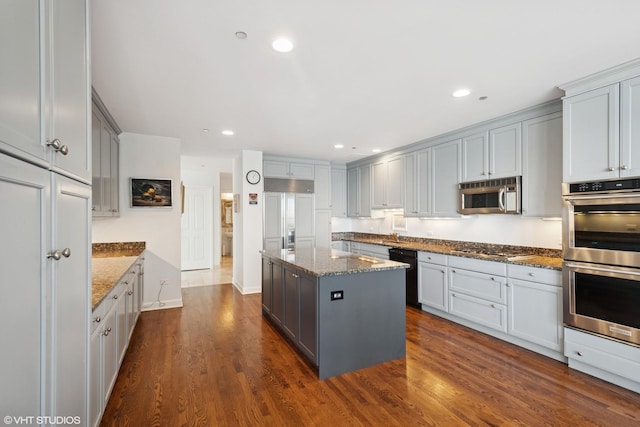 415 E N Water St Unit 2203, Chicago, IL 60611 - kitchen with stainless steel appliances, gray cabinetry, dark stone counters, a center island, and dark wood finished floors