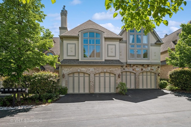 1559 S Paul Le Comte Ct, Palatine, IL 60067 - french country style house featuring driveway, stucco siding, and brick siding