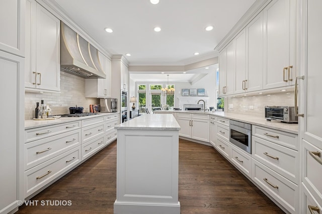 1559 S Paul Le Comte Ct, Palatine, IL 60067 - kitchen featuring wall chimney range hood, stainless steel microwave, backsplash, a sink, and recessed lighting