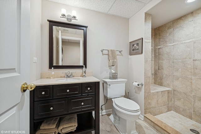 1559 S Paul Le Comte Ct, Palatine, IL 60067 - bathroom with vanity, toilet, a tile shower, baseboards, and a paneled ceiling