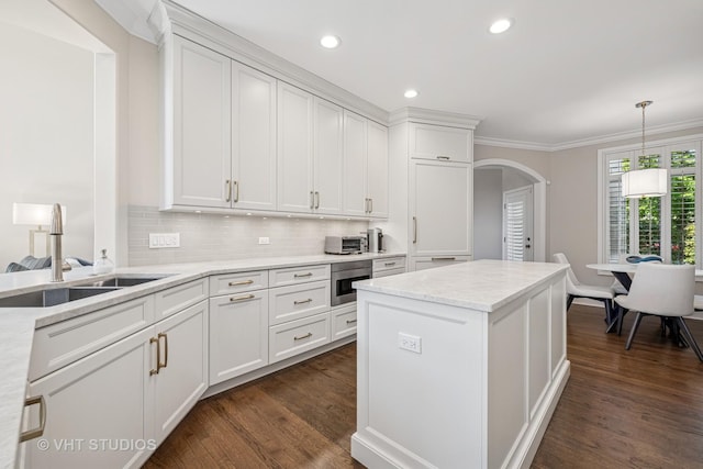 1559 S Paul Le Comte Ct, Palatine, IL 60067 - kitchen featuring a sink, arched walkways, white cabinetry, dark wood-style flooring, and ornamental molding
