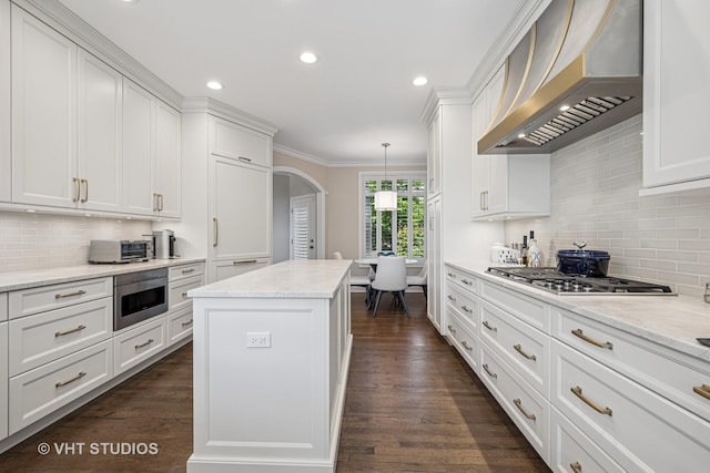 1559 S Paul Le Comte Ct, Palatine, IL 60067 - kitchen featuring wall chimney exhaust hood, arched walkways, white cabinets, tasteful backsplash, and stainless steel gas cooktop