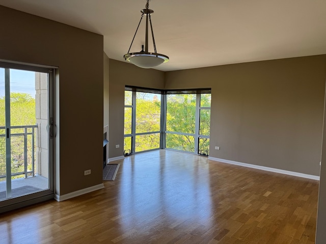 100 N Hermitage Ave Unit 409, Chicago, IL 60612 - unfurnished room featuring baseboards, healthy amount of natural light, and wood finished floors