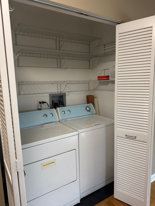100 N Hermitage Ave Unit 409, Chicago, IL 60612 - laundry area featuring washer and clothes dryer and wood finished floors