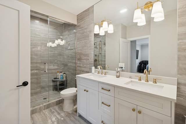 218 E 46th St, Chicago, IL 60653 - bathroom with double vanity, a shower stall, toilet, a chandelier, and marble look tiles