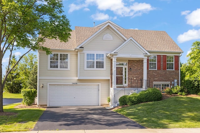 24608 George Washington Dr, Plainfield, IL 60544 - view of front of property with a garage, driveway, a front yard, brick siding, and roof with shingles