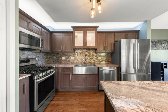 24608 George Washington Dr, Plainfield, IL 60544 - kitchen featuring stainless steel appliances, a sink, glass insert cabinets, dark wood finished floors, and backsplash