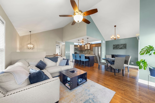 24608 George Washington Dr, Plainfield, IL 60544 - living area featuring a chandelier, high vaulted ceiling, light wood-style floors, a ceiling fan, and baseboards