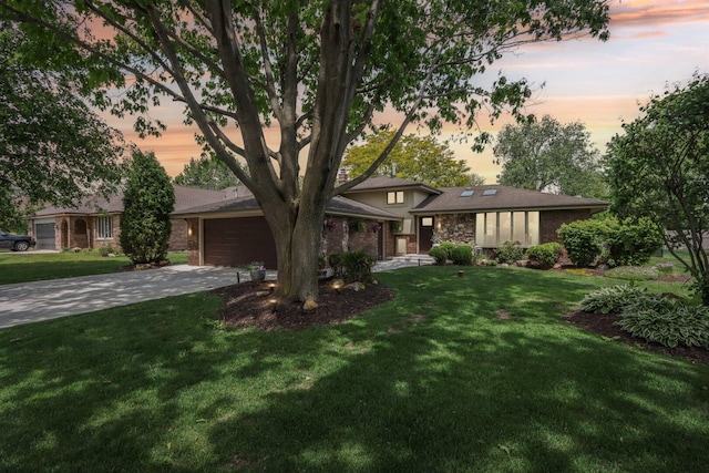 11016 84th Pl, Willow Springs, IL 60480 - view of front facade featuring driveway, an attached garage, a lawn, and stone siding