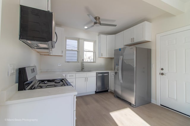 7341 S Maryland Ave, Chicago, IL 60619 - kitchen with stainless steel appliances, a sink, light wood-style floors, ceiling fan, and white cabinetry