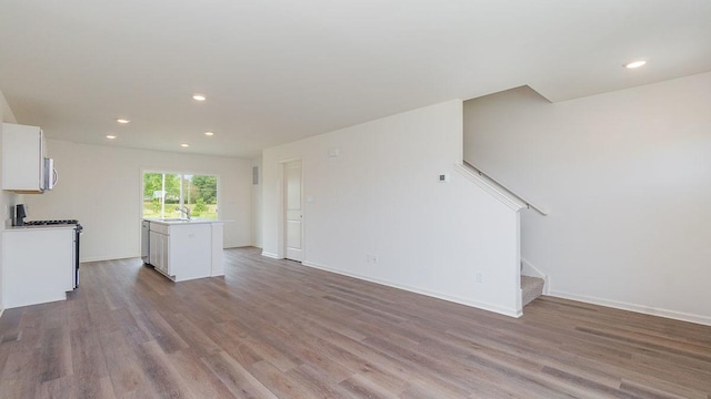 4203 High Point Ct, Joliet, IL 60436 - unfurnished living room with a sink, stairway, wood finished floors, recessed lighting, and baseboards