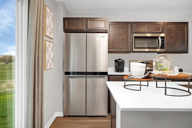 4203 High Point Ct, Joliet, IL 60436 - kitchen featuring stainless steel appliances, dark brown cabinets, light wood-style flooring, light countertops, and baseboards