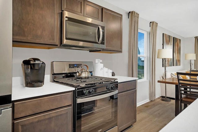 4203 High Point Ct, Joliet, IL 60436 - kitchen featuring stainless steel appliances, light wood-style floors, light countertops, dark brown cabinets, and baseboards