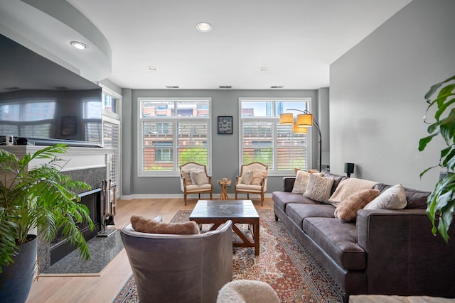 550 W Fulton St Unit 303, Chicago, IL 60661 - living area featuring wood finished floors, a fireplace with flush hearth, recessed lighting, and baseboards