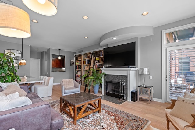 550 W Fulton St Unit 303, Chicago, IL 60661 - living area featuring recessed lighting, plenty of natural light, wood finished floors, baseboards, and a fireplace with flush hearth