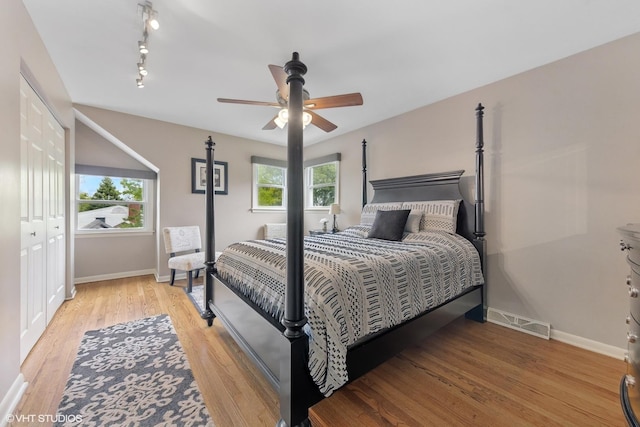 4N671 Petersdorf Rd, West Chicago, IL 60185 - bedroom with baseboards, light wood-style floors, rail lighting, and a ceiling fan