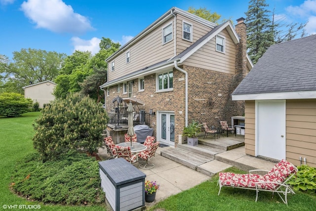 4N671 Petersdorf Rd, West Chicago, IL 60185 - back of house featuring a lawn, a chimney, a wooden deck, brick siding, and french doors