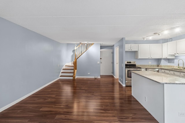 711 W Gordon Ter Unit 117, Chicago, IL 60613 - kitchen featuring appliances with stainless steel finishes, dark wood-style flooring, light stone counters, baseboards, and white cabinetry