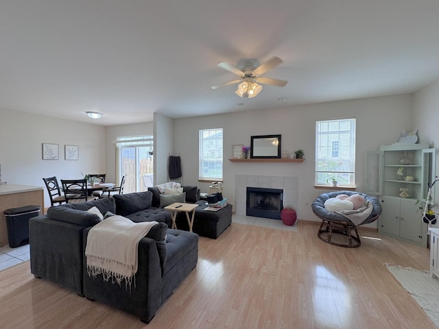 3854 Trading Post Ln, Joliet, IL 60435 - living room with light wood-type flooring, healthy amount of natural light, a fireplace, and a ceiling fan