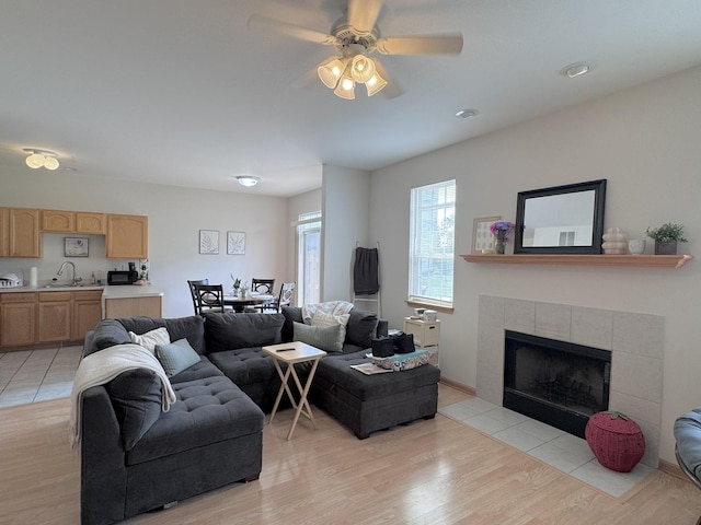 3854 Trading Post Ln, Joliet, IL 60435 - living room with a ceiling fan, a tiled fireplace, and light wood-style flooring