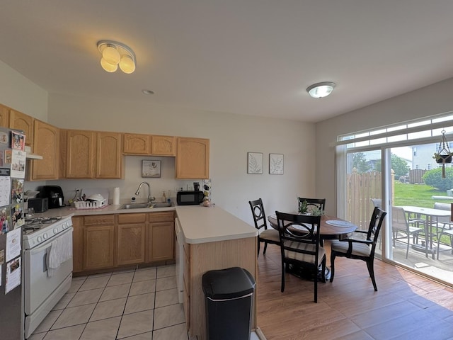 3854 Trading Post Ln, Joliet, IL 60435 - kitchen featuring light brown cabinetry, white range with gas cooktop, a sink, light countertops, and freestanding refrigerator