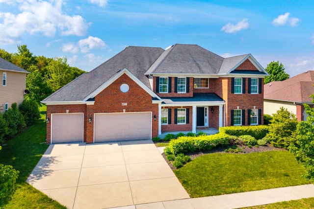 677 Slate Run, Elgin, IL 60124 - view of front of home with brick siding, driveway, an attached garage, and a front yard