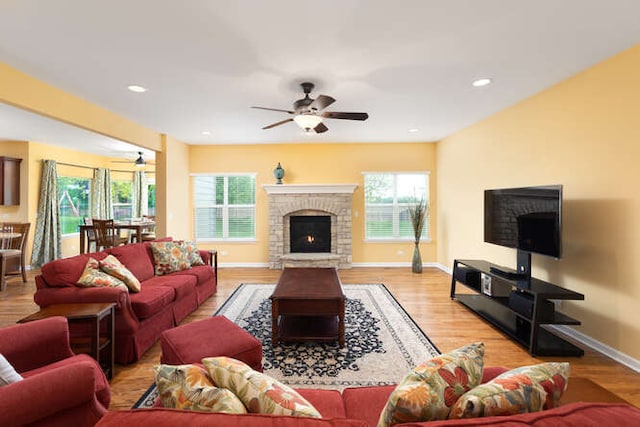 677 Slate Run, Elgin, IL 60124 - living room featuring a warm lit fireplace, a ceiling fan, wood finished floors, baseboards, and recessed lighting