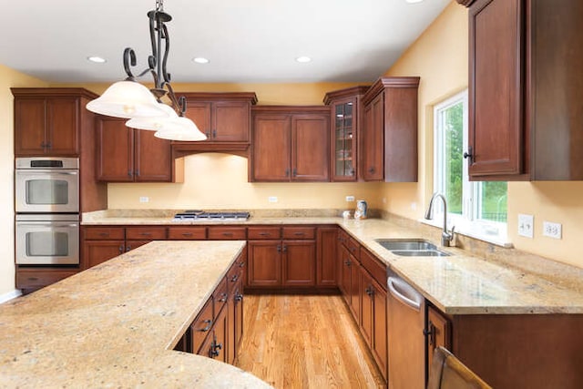 677 Slate Run, Elgin, IL 60124 - kitchen featuring appliances with stainless steel finishes, a sink, light stone counters, pendant lighting, and light wood-style floors