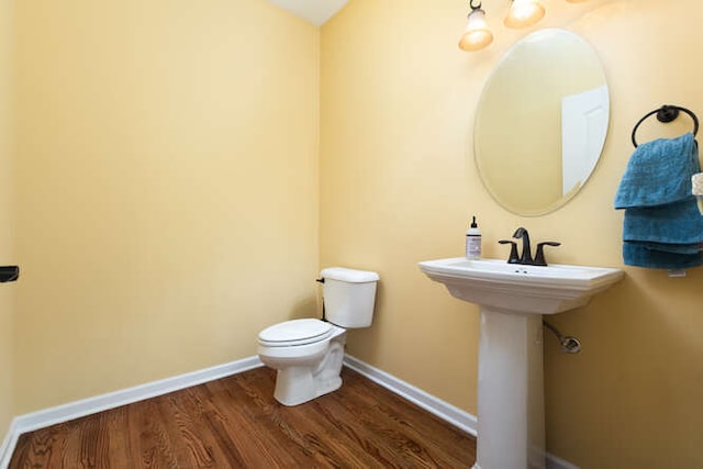 677 Slate Run, Elgin, IL 60124 - half bath featuring wood finished floors, toilet, and baseboards