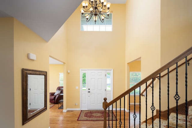 677 Slate Run, Elgin, IL 60124 - foyer with a chandelier, healthy amount of natural light, wood finished floors, and a high ceiling