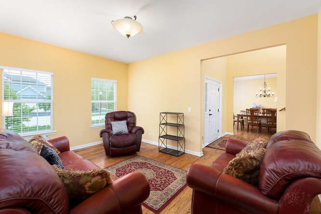 677 Slate Run, Elgin, IL 60124 - living room with a chandelier, wood finished floors, and baseboards
