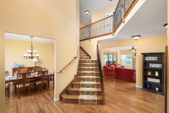 677 Slate Run, Elgin, IL 60124 - stairway with a chandelier, wood finished floors, a high ceiling, a ceiling fan, and baseboards
