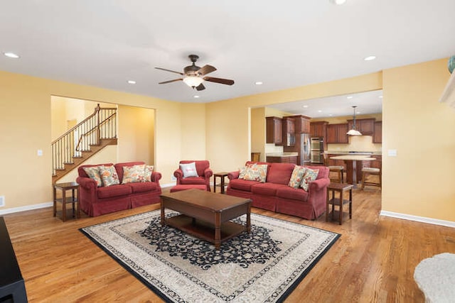 677 Slate Run, Elgin, IL 60124 - living room with light wood-style flooring, baseboards, ceiling fan, recessed lighting, and stairway