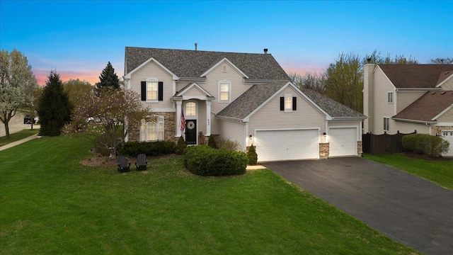 605 Acorn Ct, Antioch, IL 60002 - traditional-style house with driveway, a garage, stone siding, and a front lawn