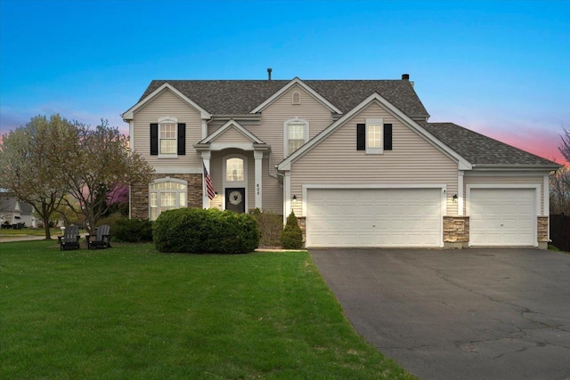 605 Acorn Ct, Antioch, IL 60002 - traditional-style home featuring asphalt driveway, stone siding, a yard, and a shingled roof