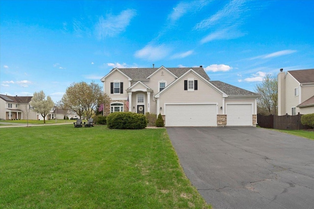 605 Acorn Ct, Antioch, IL 60002 - traditional-style house with asphalt driveway, an attached garage, and stone siding