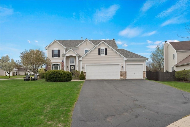 605 Acorn Ct, Antioch, IL 60002 - traditional-style house with asphalt driveway, stone siding, and an attached garage