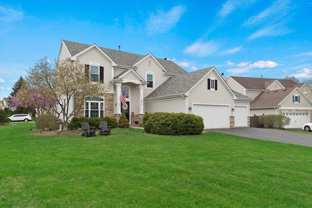 605 Acorn Ct, Antioch, IL 60002 - traditional-style house with asphalt driveway, a front yard, stone siding, and an attached garage