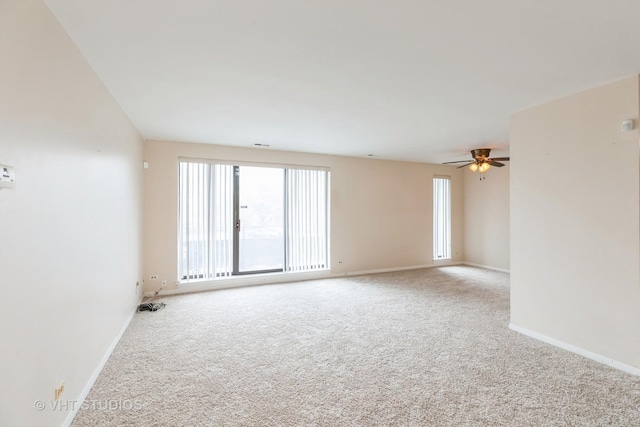 5 E Carriageway Dr Unit 209, Hazel Crest, IL 60429 - carpeted empty room with healthy amount of natural light, a ceiling fan, and baseboards