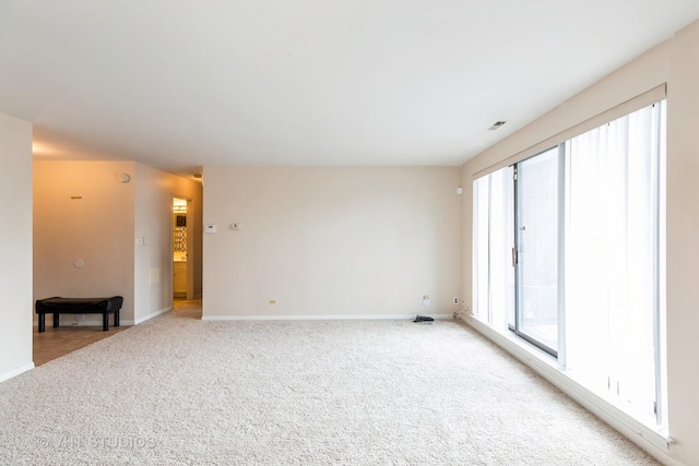 5 E Carriageway Dr Unit 209, Hazel Crest, IL 60429 - spare room featuring healthy amount of natural light, light carpet, and baseboards