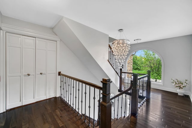 24161 Brancaster Dr, Naperville, IL 60564 - hallway with dark wood-style floors, a chandelier, an upstairs landing, and baseboards