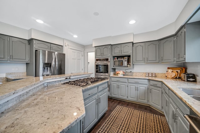24161 Brancaster Dr, Naperville, IL 60564 - kitchen featuring gray cabinets, appliances with stainless steel finishes, dark wood-type flooring, light stone counters, and recessed lighting