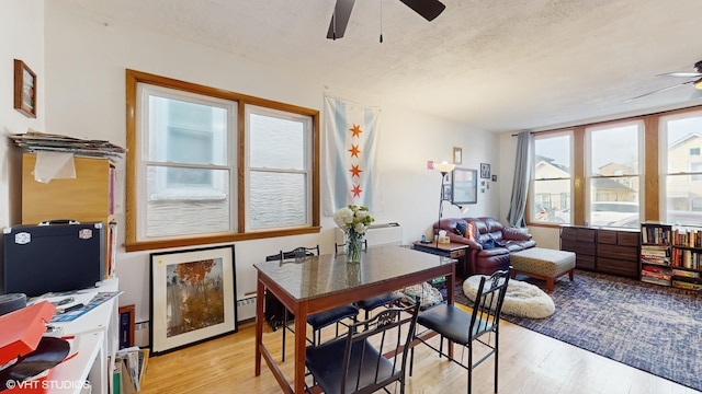 2851 S Keeley St, Chicago, IL 60608 - dining area featuring a ceiling fan, a textured ceiling, light wood-style floors, a baseboard radiator, and an office area