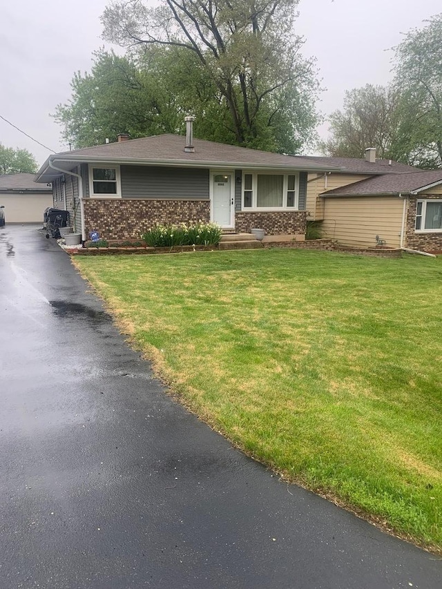 10100 W Chaplin Ave, Beach Park, IL 60087 - view of front facade with a front yard and brick siding
