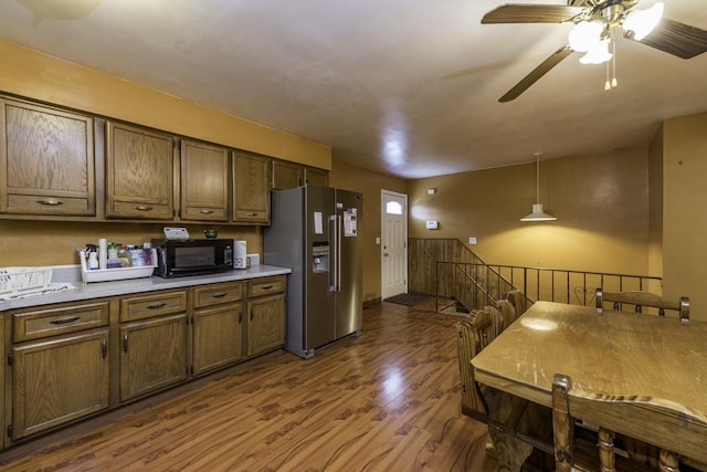 10100 W Chaplin Ave, Beach Park, IL 60087 - kitchen with stainless steel fridge, black microwave, dark wood finished floors, a ceiling fan, and light countertops