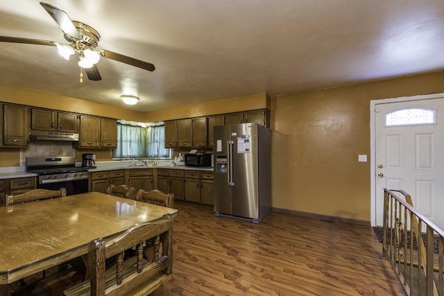 10100 W Chaplin Ave, Beach Park, IL 60087 - kitchen featuring appliances with stainless steel finishes, under cabinet range hood, ceiling fan, dark wood finished floors, and light countertops
